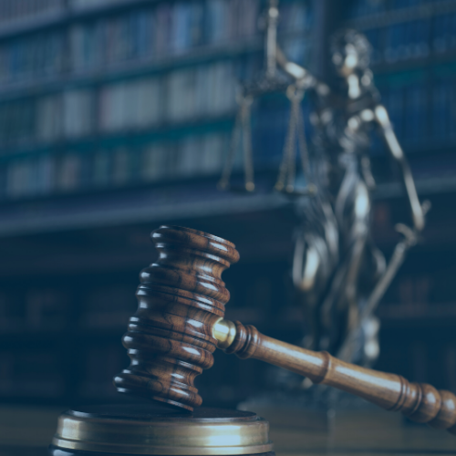 gavel and lady liberty with law books in the background