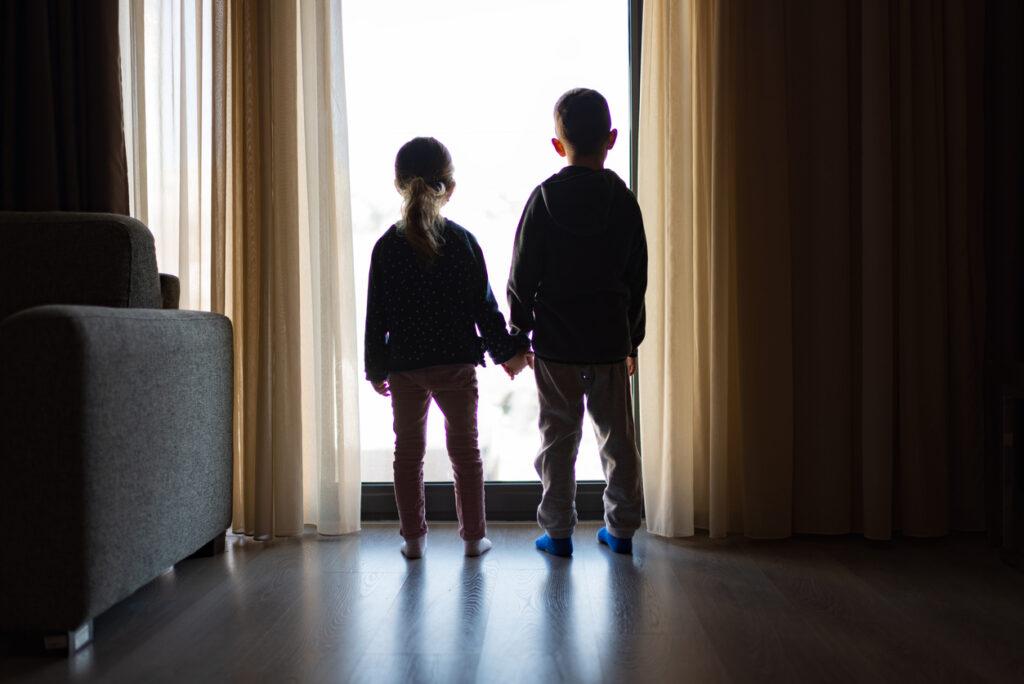 boy-and-girl-looking-at-window