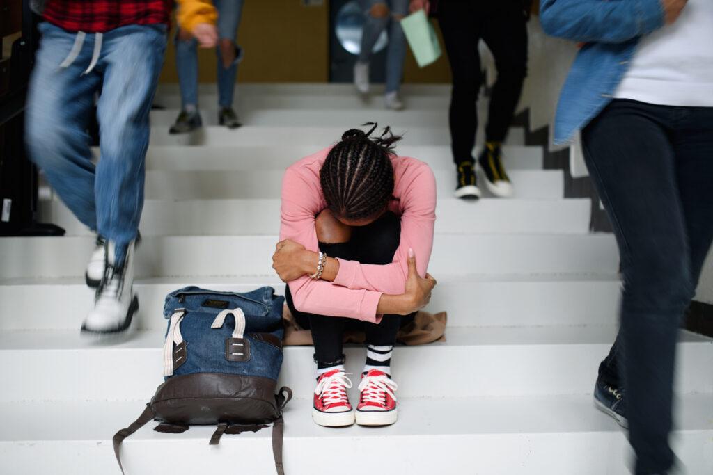 depressed-college-student-sitting-on-stairway 