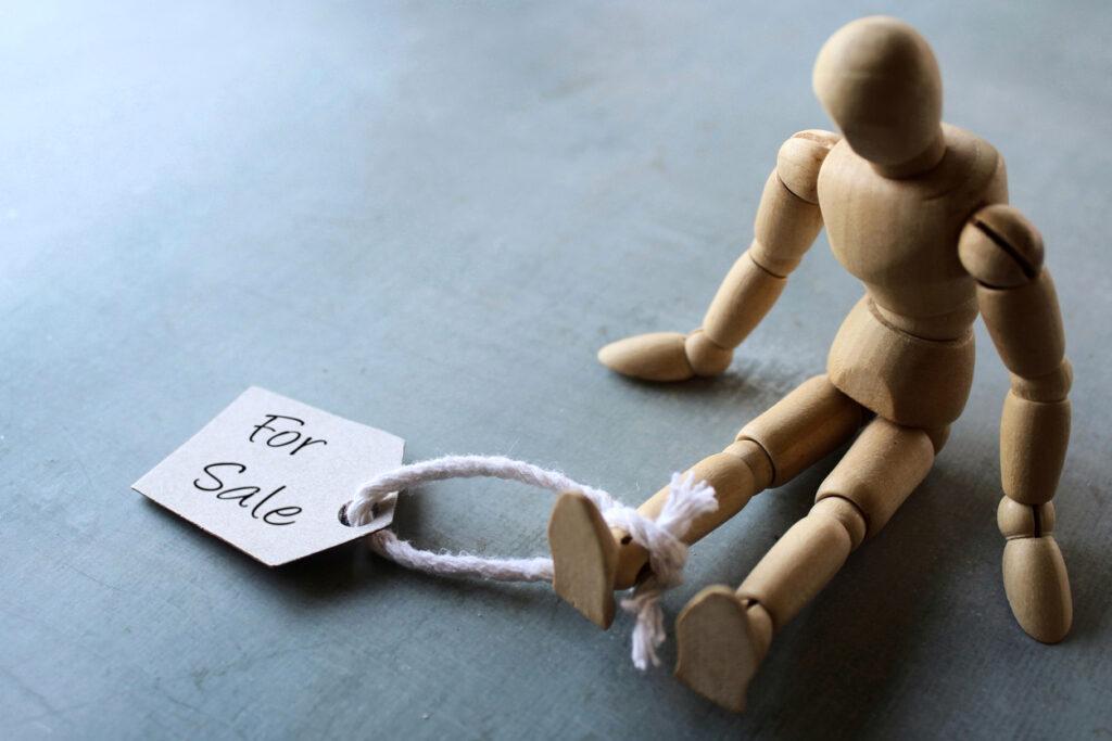 Doll with tag for sale to illustrate human trafficking.
