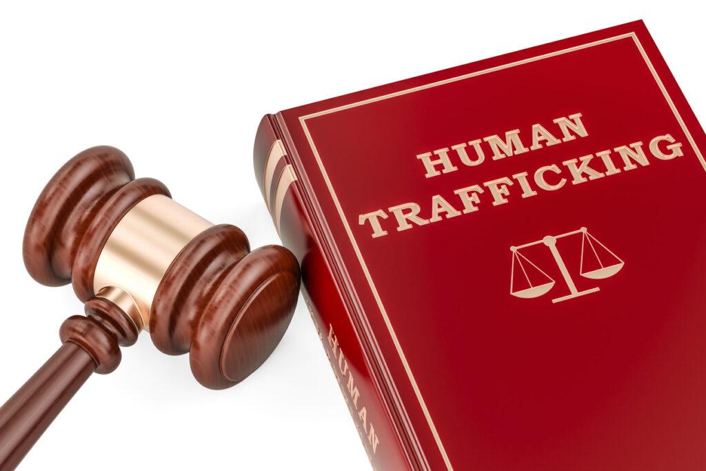 Human trafficking book with gavel.