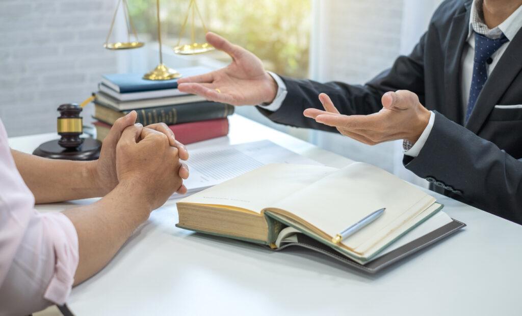 Man consulting a criminal defense attorney at a law firm.