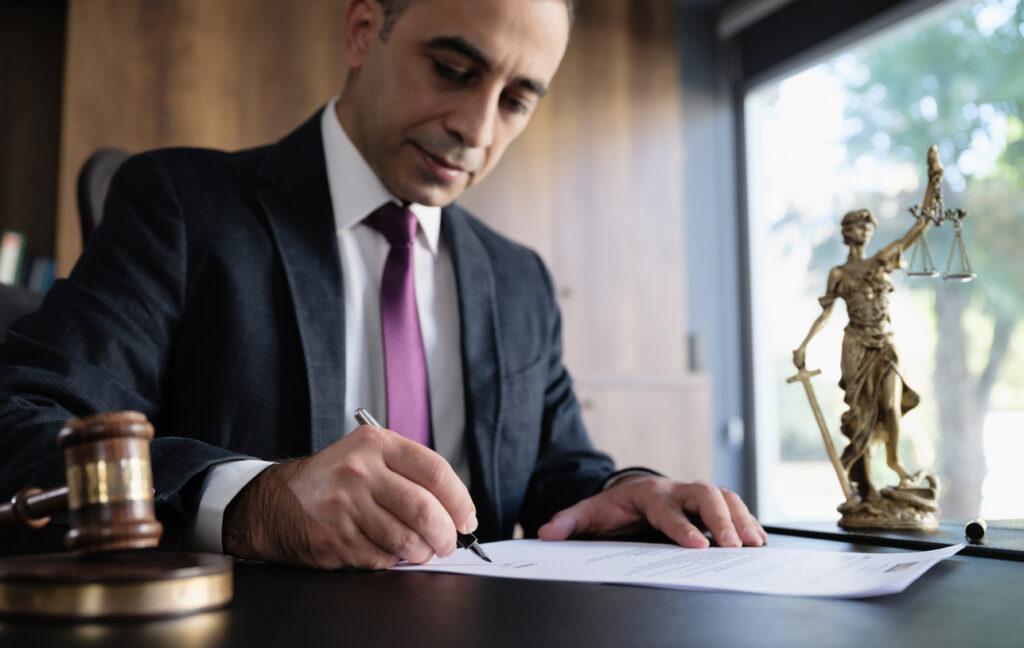 Lawyer examining and signing legal documents.