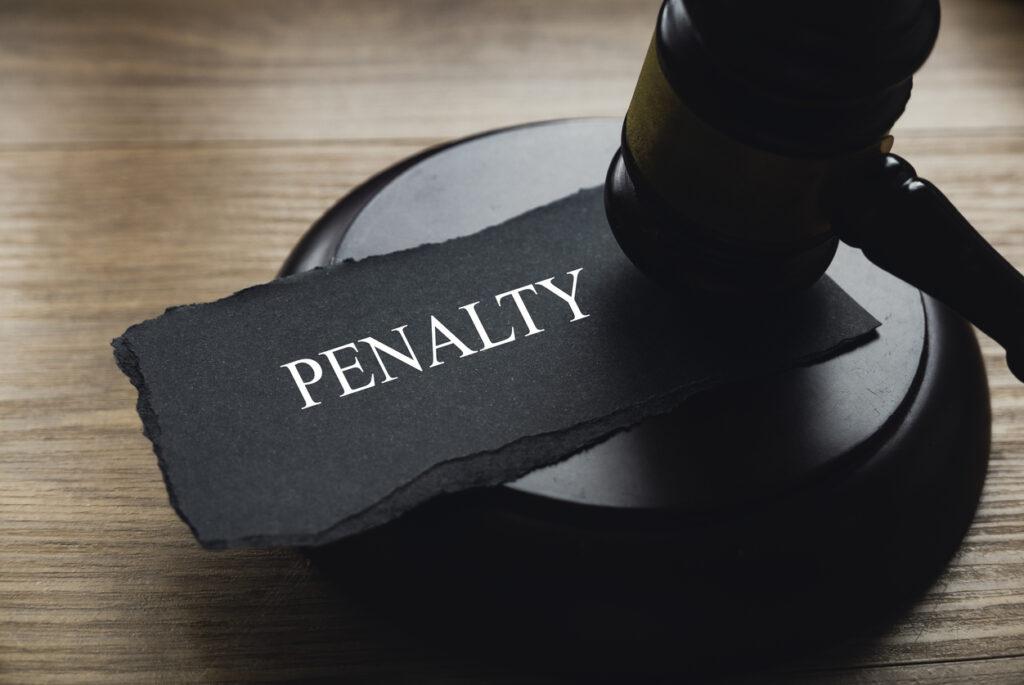 A gavel and a piece of paper written with Penalty.