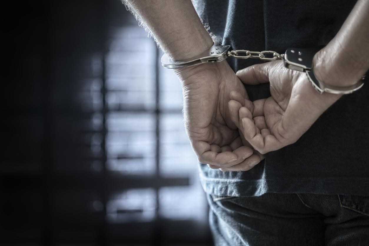 Man in handcuffs in a prison.