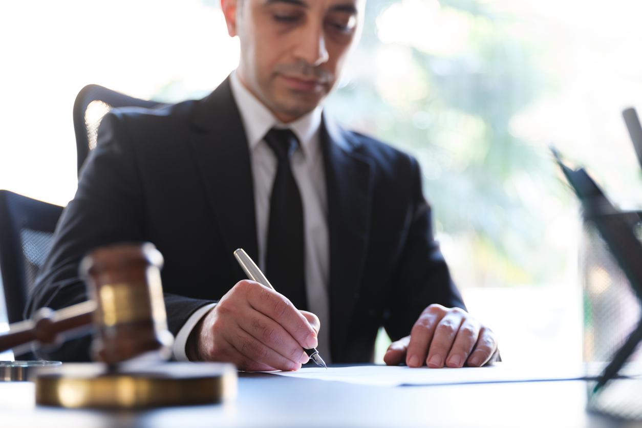 Lawyer signing in legal papers.